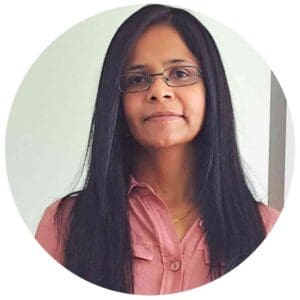 Professional portrait of a woman with long black hair and glasses at Equana Minds.