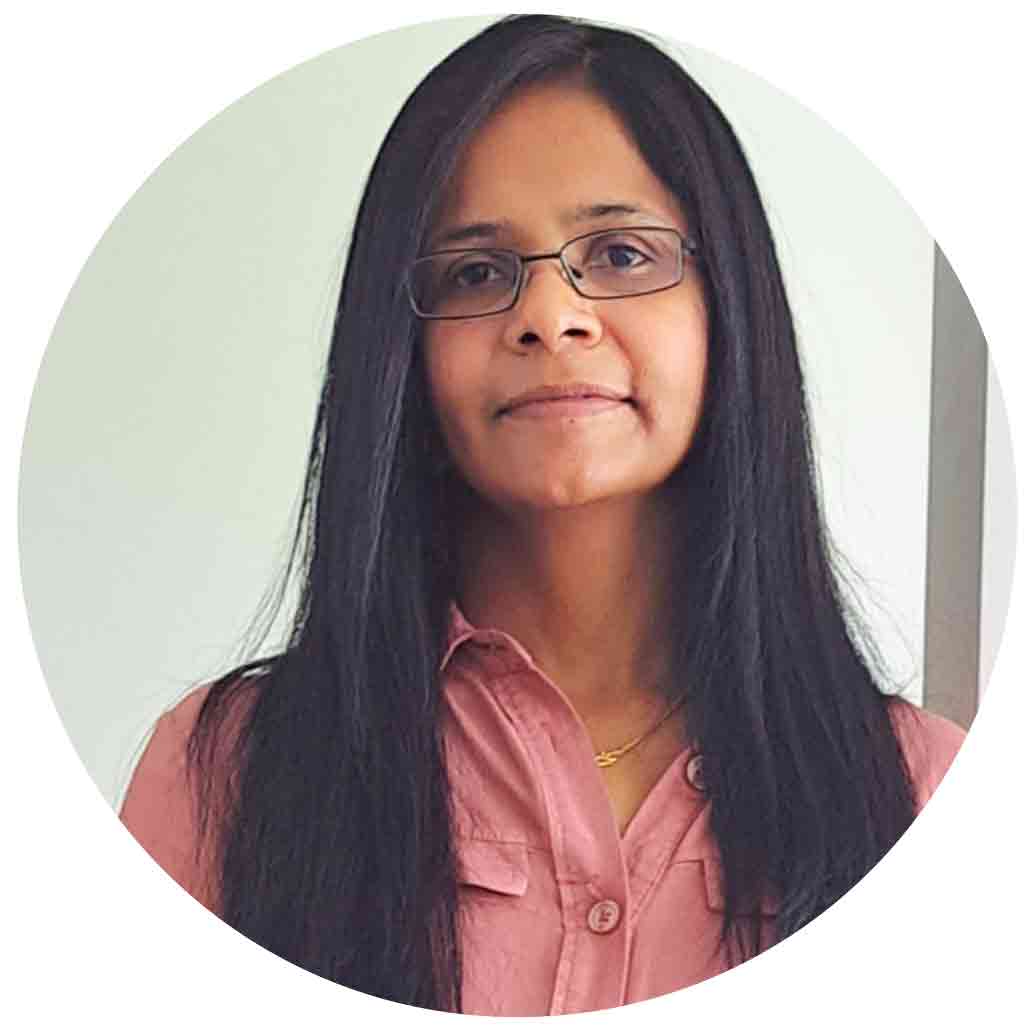 Professional portrait of a woman with long black hair and glasses at Equana Minds.